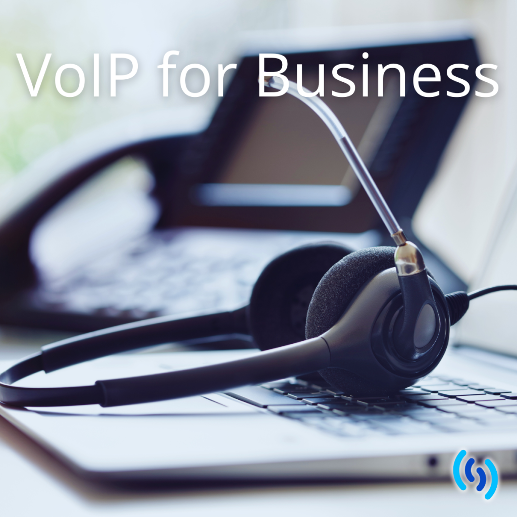 This is an image of a laptop with a voip phone headset laid on the keypad. In the background is a voip phone. Across the top in white lettering it says 'voip for business'