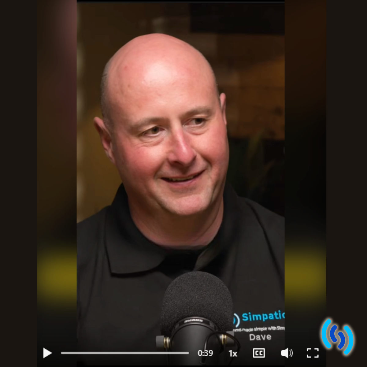 Dave Spittlehouse wearing black on with a podcast microphone in front of him.